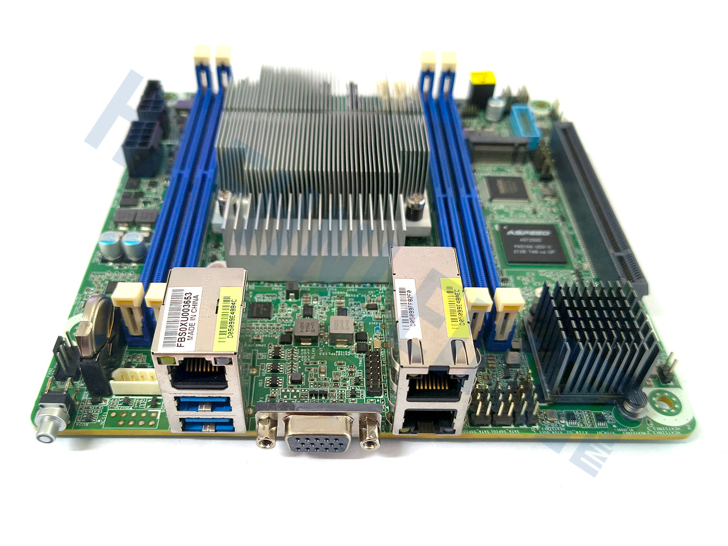 A green Asrock Rack EPYC3451D412-2T motherboard with blue RAM slots, a large silver heatsink, close-up of various ports, on a white background.
