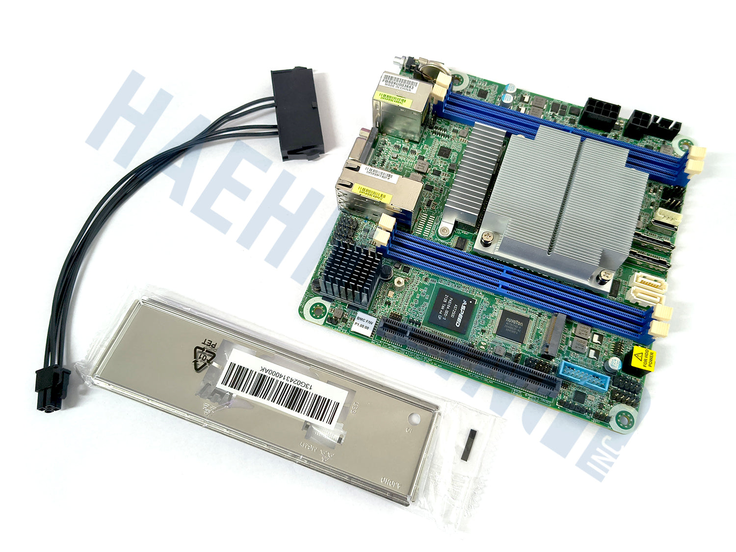 A green Asrock Rack EPYC3451D412-2T motherboard with blue RAM slots, a large silver heatsink, and various connectors, shown alongside a silver metal I/O shield in plastic wrapping and a black power adapter on a white background.